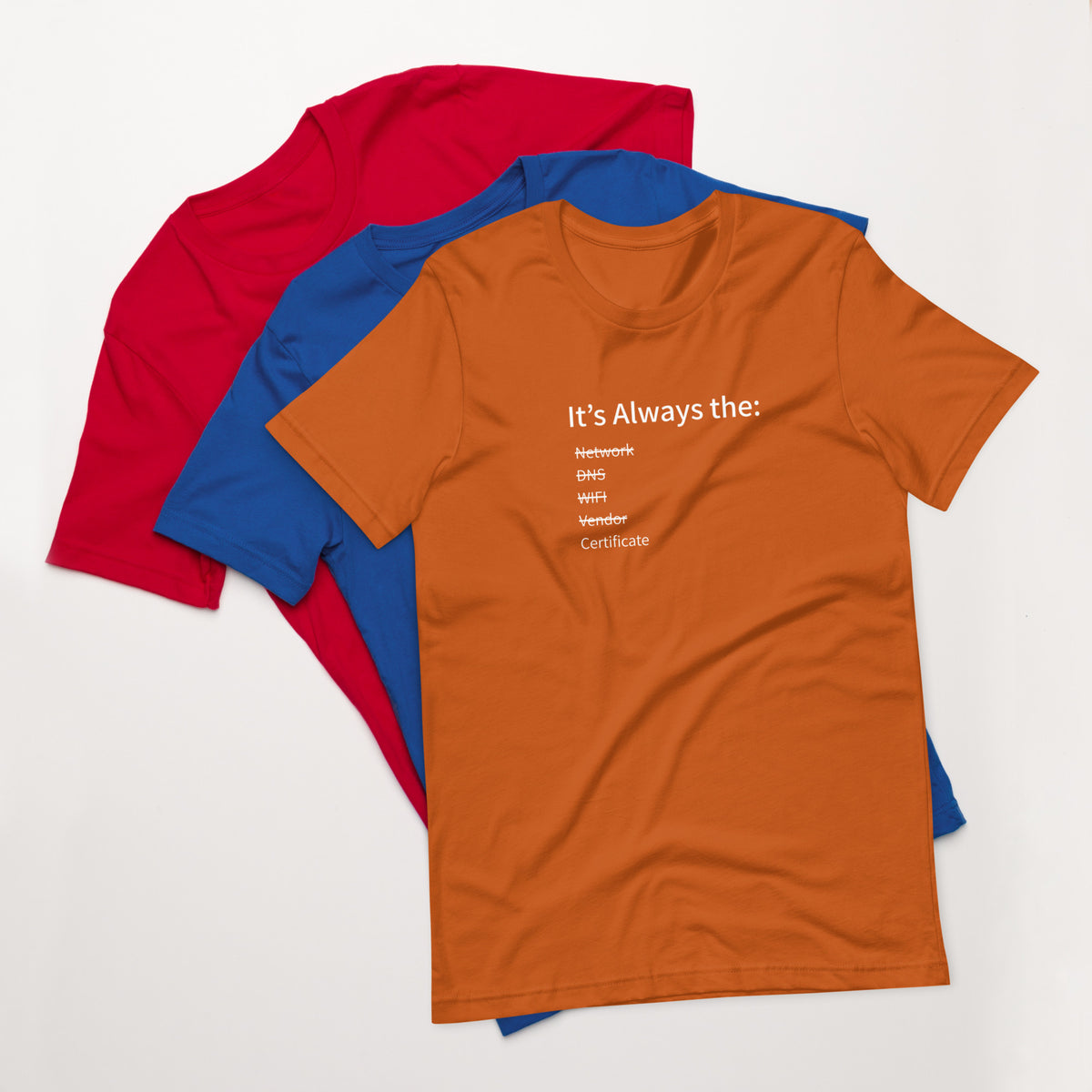 A stack of t-shirts in different colors that has a list of things that cause computer system outages that would be funny to an IT Professional.