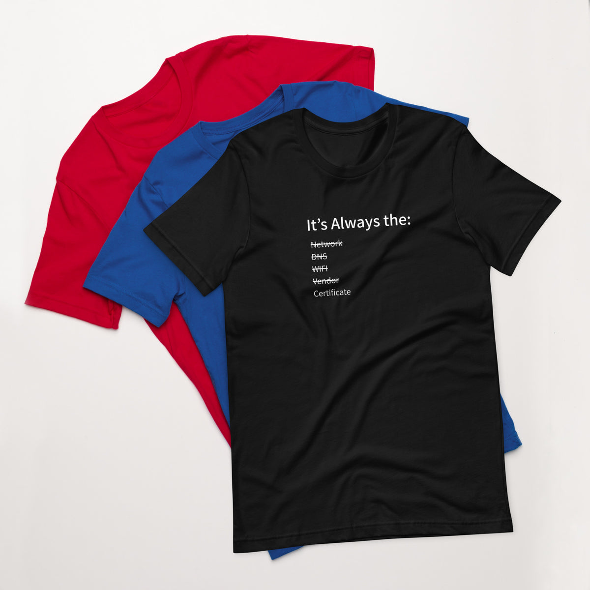 A stack of t-shirts in different colors that has a list of things that cause computer system outages that would be funny to an IT Professional.
