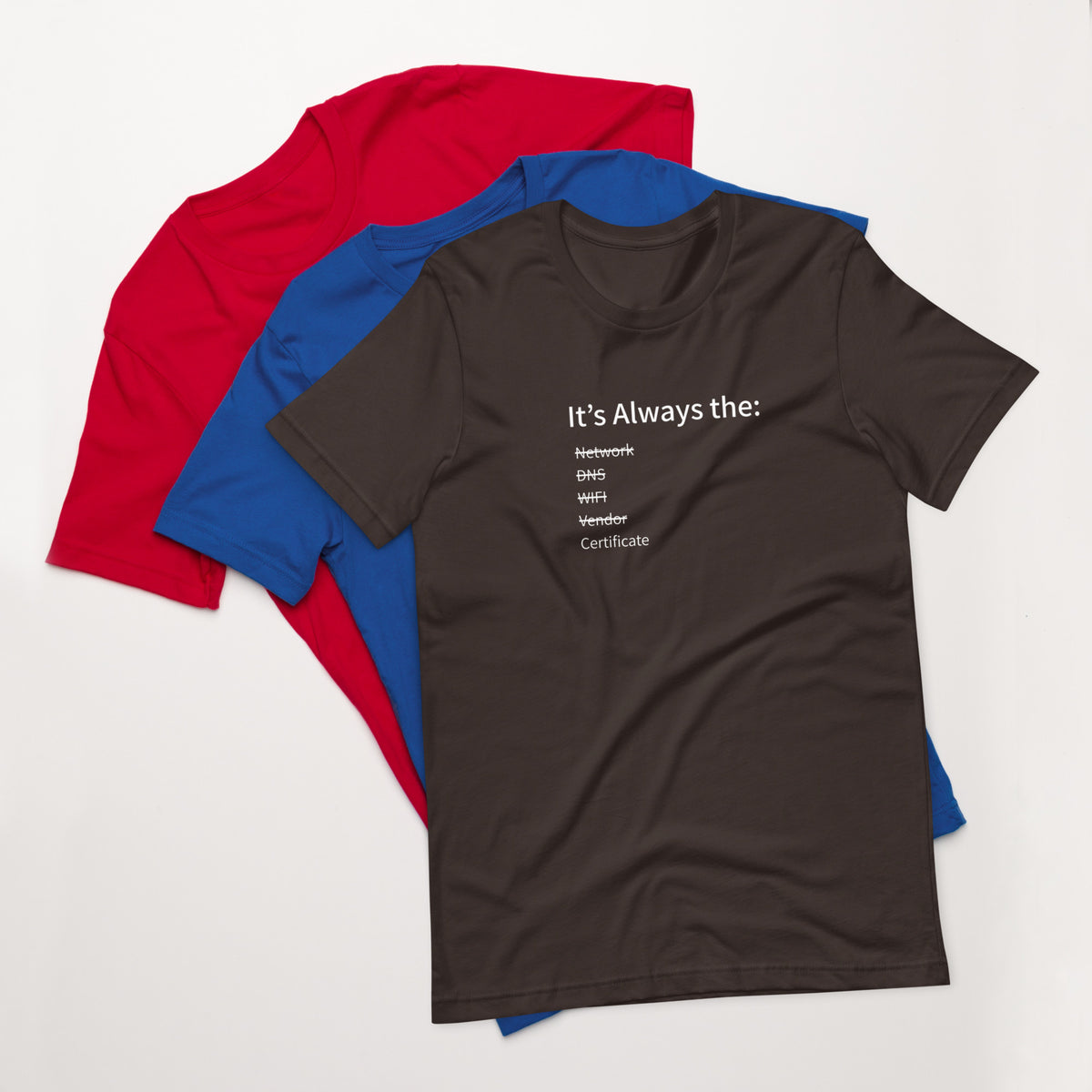 A stack of t-shirts in different colors that has a list of things that cause computer system outages that would be funny to an IT Professional.
