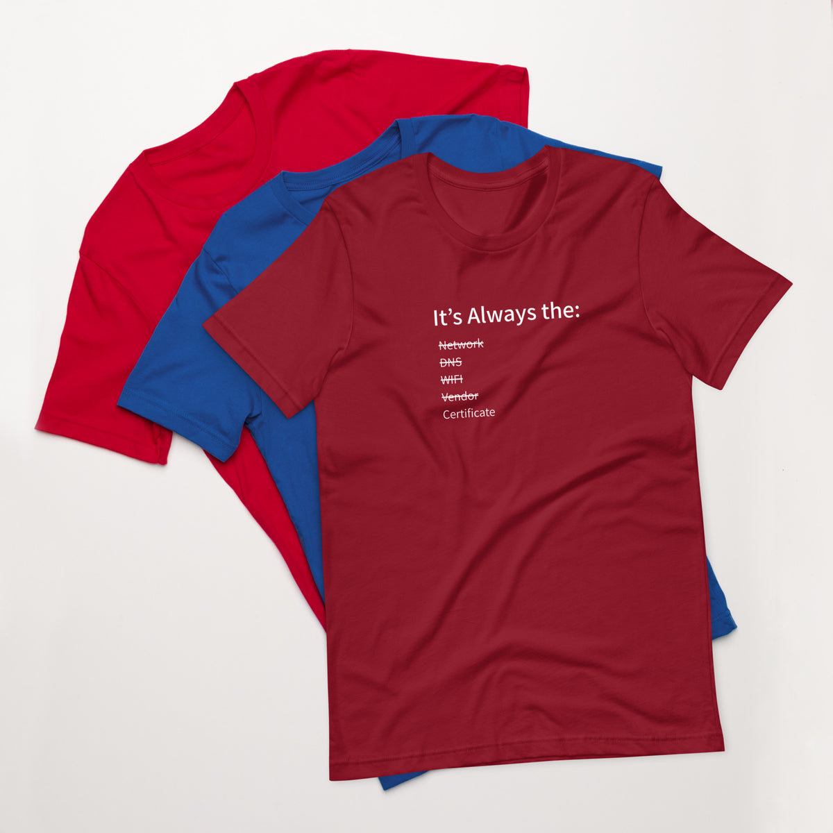 A stack of t-shirts in different colors that has a list of things that cause computer system outages that would be funny to an IT Professional.