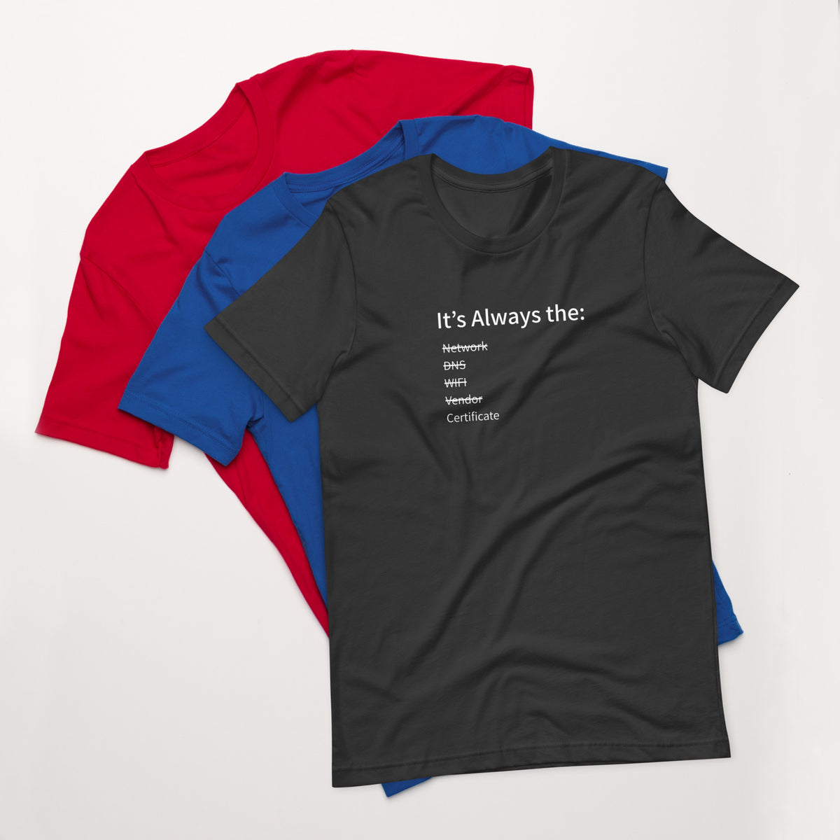 A stack of t-shirts in different colors that has a list of things that cause computer system outages that would be funny to an IT Professional.