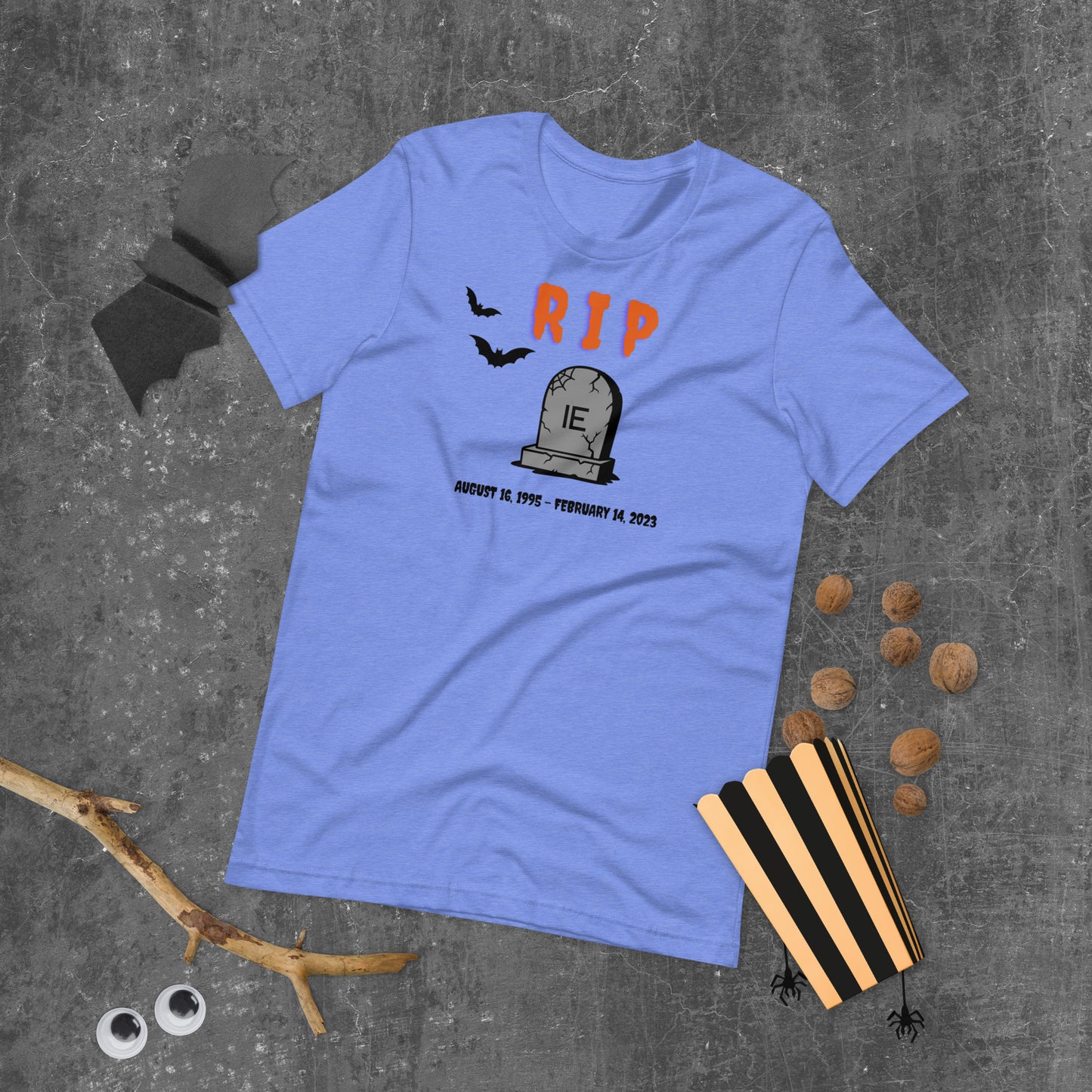 A Halloween T-Shirt for Sysadmins that shows a picture of a tombstone with the letters IE on it and the title RIP and the date Internet Explorer premiered and the date that it was disabled.