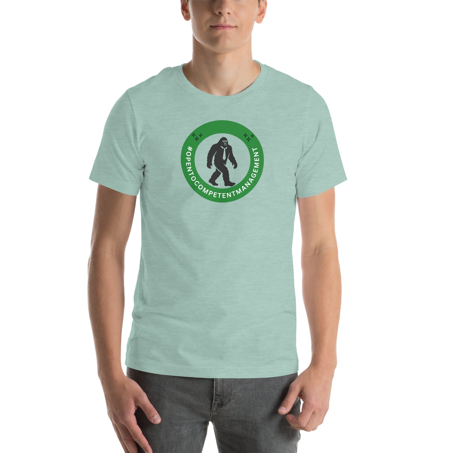 A t-shirt that shows a work status  badge that says #OpenToCompetentManagement with a picture of a bigfoot in a tie.