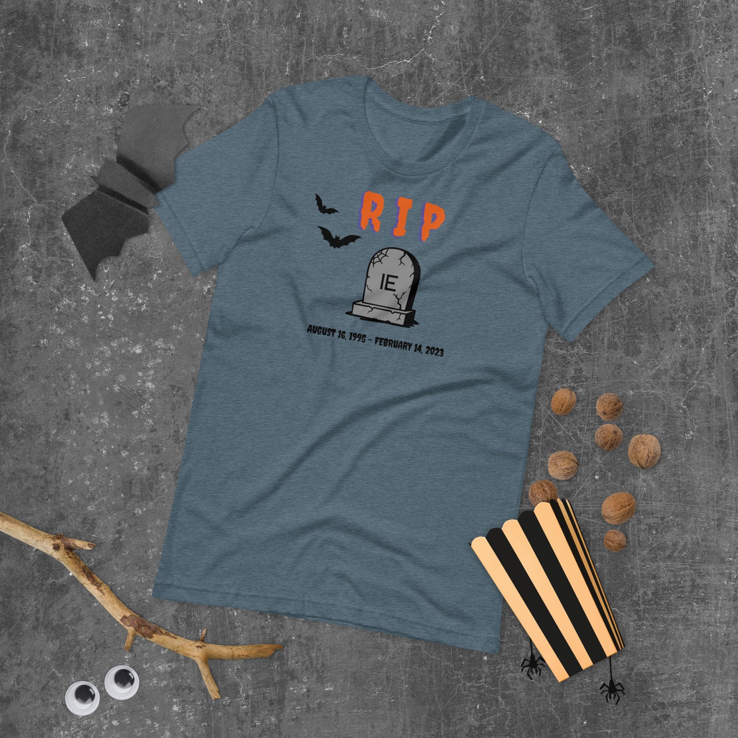 A Halloween T-Shirt for Sysadmins that shows a picture of a tombstone with the letters IE on it and the title RIP and the date Internet Explorer premiered and the date that it was disabled.