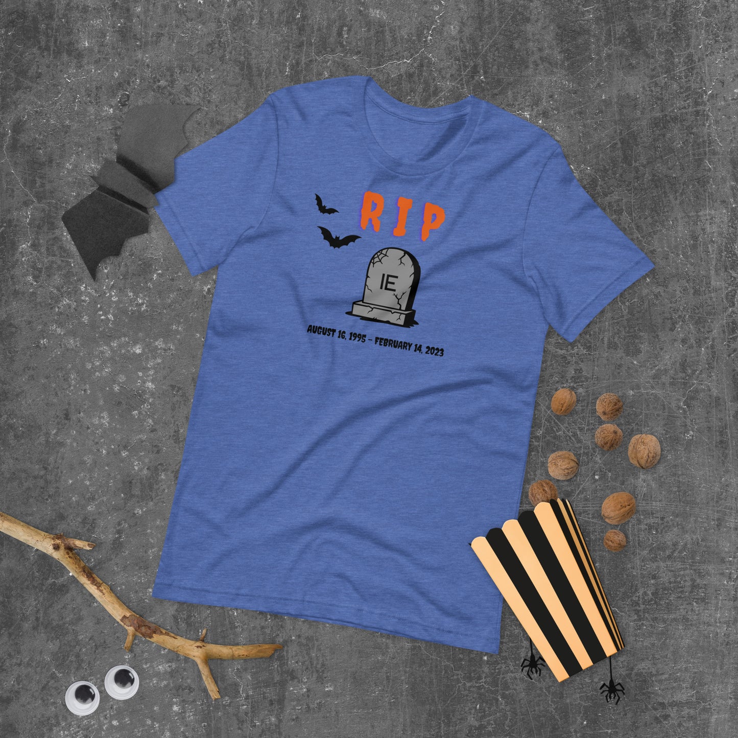 A Halloween T-Shirt for Sysadmins that shows a picture of a tombstone with the letters IE on it and the title RIP and the date Internet Explorer premiered and the date that it was disabled.