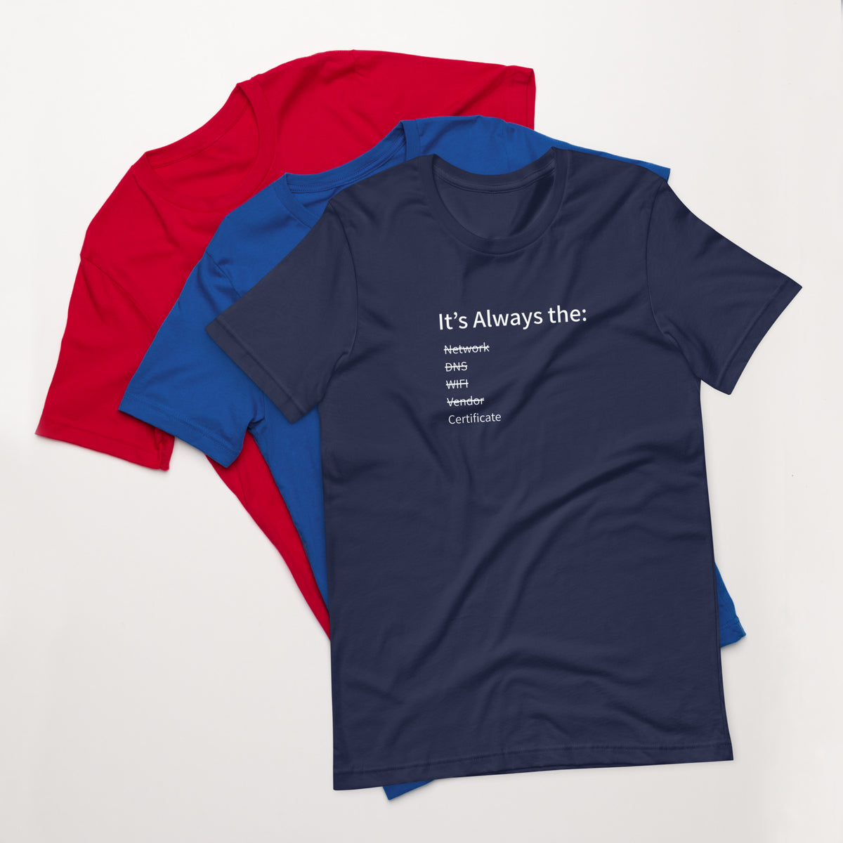 A stack of t-shirts in different colors that has a list of things that cause computer system outages that would be funny to an IT Professional.