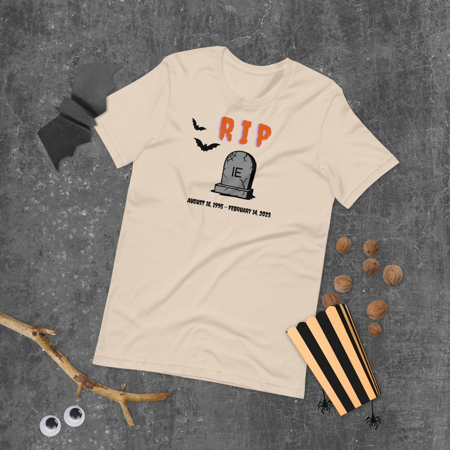 A Halloween T-Shirt for IT Professionals that shows a picture of a tombstone with the letters IE on it and the title RIP and the date Internet Explorer premiered and the date that it was disabled.