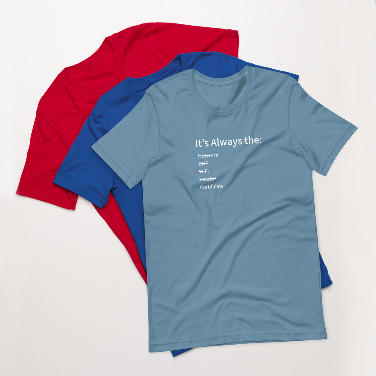 A stack of t-shirts in different colors that has a list of things that cause computer system outages that would be funny to an IT Professional.