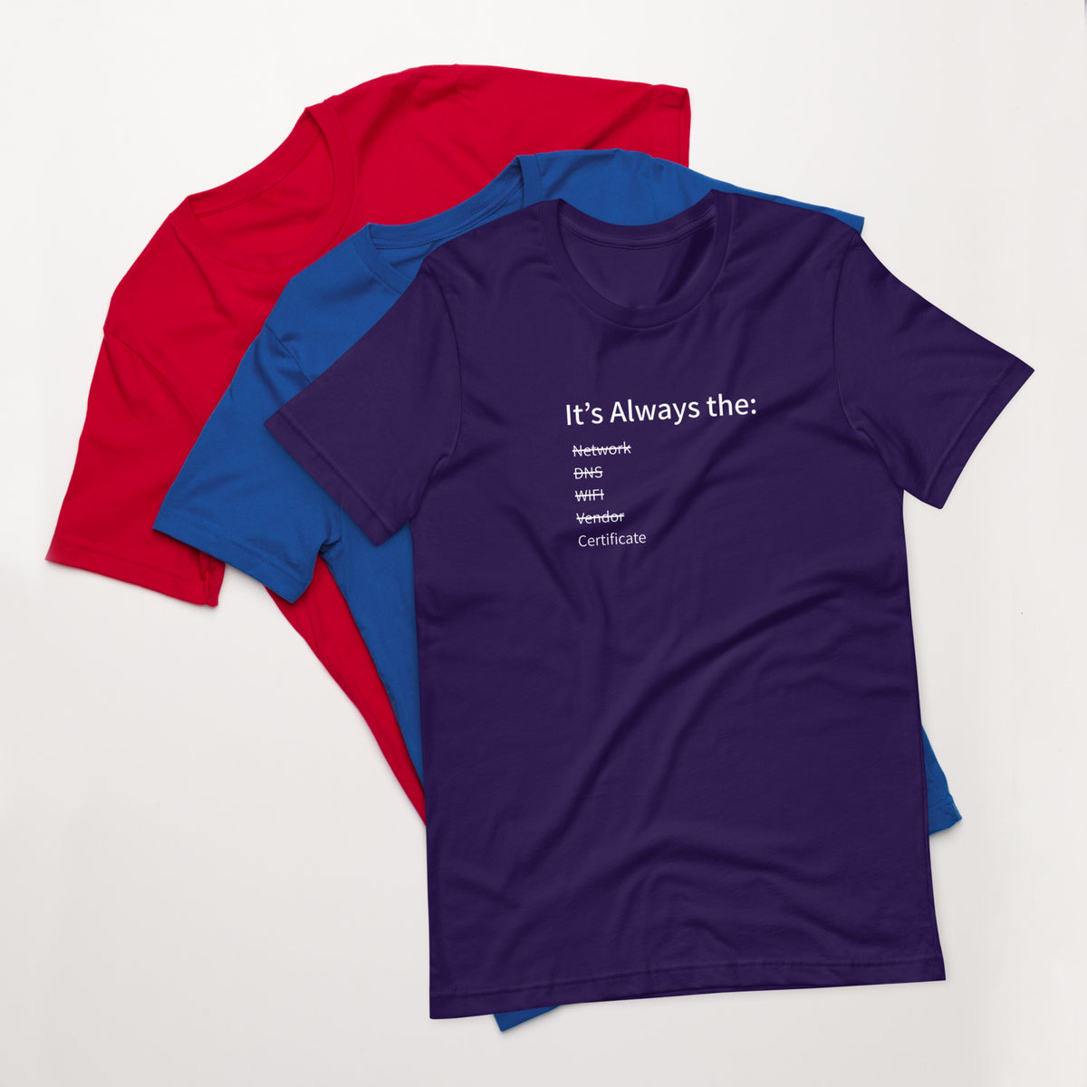 A stack of t-shirts in different colors that has a list of things that cause computer system outages that would be funny to an IT Professional.