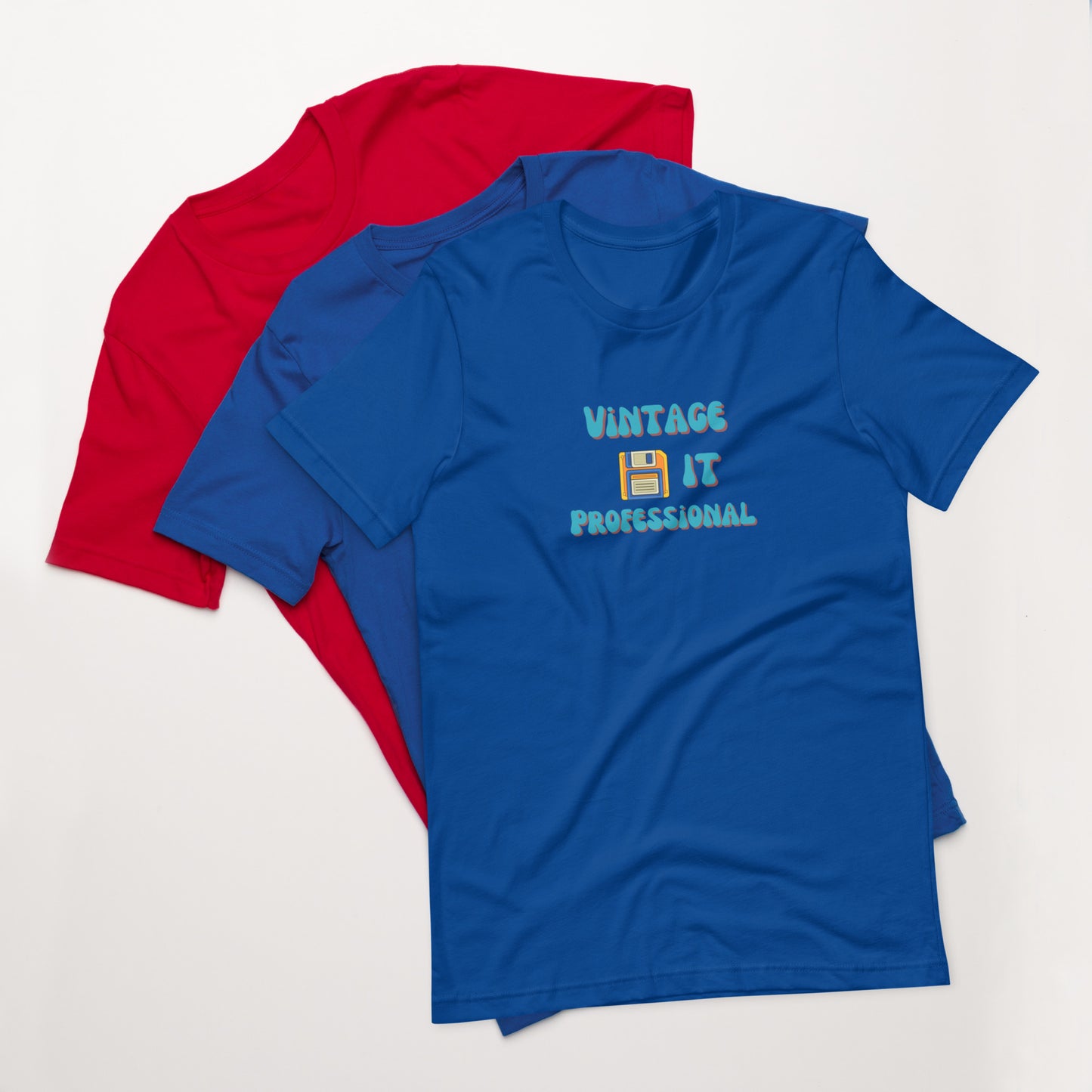 A stack of t-shirts with a blue one on top that says Vintage IT Professional and has a picture of a diskette on it.