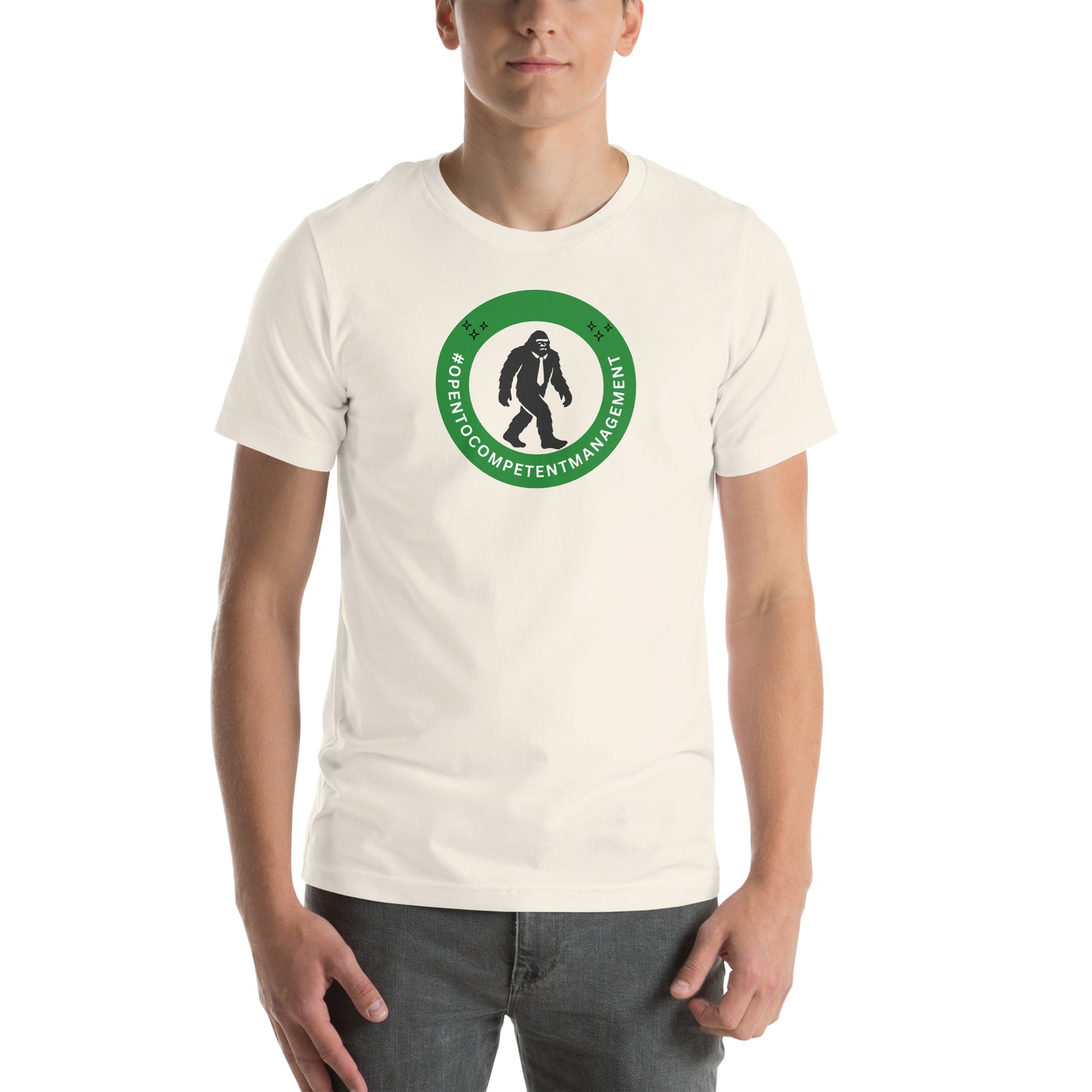 A t-shirt that shows a work status  badge that says #OpenToCompetentManagement with a picture of a bigfoot in a tie.